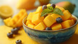 Tropical fruit, Mango cube slices in bowl on yellow background.