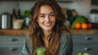 Beautiful happy woman sitting with drinks and healthy green food at home. Vegan meal and detox concept.