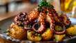 Octopus atop potatoes, garnished with parsley
