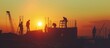Silhouette of Engineer, constructor, worker on building site, High steel platform, construction view at sunset in evening time.