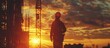 Silhouette of Engineer, constructor, worker on building site, High steel platform, construction view at sunset in evening time.