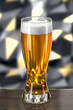 Glass with beer on wooden table on background of wall with spotlights. Bar theme. Dark environment. 3d rendering.