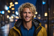Portrait of a smiling blonde man with blue eyes in the evening city in rainy weather.
