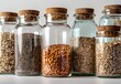 a row of glass jars filled with different types of grains and seeds
