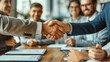 © aekkorn - Young business people meeting office handshake hand shake shaking hands teamwork group contract signing agreement document signature paperwork success corporate senior mature.