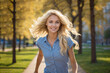© Александр Поташев - A beautiful girl in a sports uniform, blonde with blue eyes is running in the park.Full-length photo.Smiling. It's a sunny day.