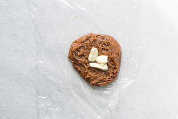 Sticker - Overhead view of brown sugar cookie dough being filled with chocolate chunks