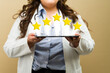 Closeup of an overweight doctor displaying a five-star review on a tablet, endorsing outstanding service