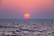 © vadimborkin - dawn over the sea, yellow-red sun close-up