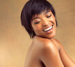 Short hair, skincare or happy black woman in studio for keratin growth, healthy shine or wellness. Model, shampoo cosmetics or confident girl with natural texture, body or glow on brown background