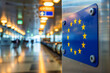 © ninakosh - EU Border and Immigration Sign in Airport Corridor, European Union Flag at Airport Terminal