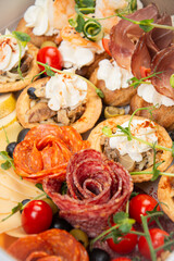 Wall Mural - Meat snacks with cream cheese, vegetables and salami close-up