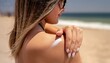 © Eggy - Woman smearing Sun screen on her body - Protection against UV Light - Female on the Beach in the Summer