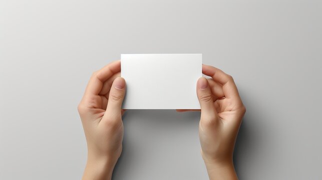 Business hand holding a business card mock-up on a white background. Use for mock-ups and tempalte.