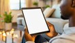 © Eggy - Tablet held by Man in a Living Room - Mockup for Application or Web Design - Template for Presentation of Graphic Design - Corporate Representation at Consumers
