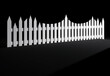 An uneven white picket fence; concept of uneven, unpredictable order amidst chaos or unruly neighbors, isolated on black