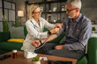 © Miljan Živković - mature man have home visit by a doctor to measure his blood pressure