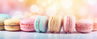 Colorful macarons stacked with a bokeh light effect in the background, representing indulgence and sweetness