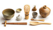 Traditional Japanese tea ceremony utensils arranged neatly on a white background.