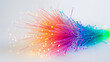 A vibrant explosion of fiber optic lights in a spectrum of colors against a white backdrop.
