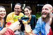 © Xavier Lorenzo - Happy multiracial young friends enjoying cocktail drink at bar terrace. Millennial people having fun enjoying summer party during happy hour on summer vacation.