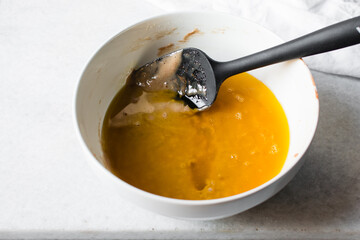 Sticker - Mixing Melted butter and Madeleine batter in a white mixing bowl