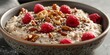 a bowl of oatmeal topped with raspberries, chopped walnuts, pumpkin seeds, and a sprinkle of sesame seeds