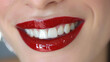 Glossy lips in a vibrant shade of red, exuding confidence and elegance with every smile.