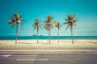 Palm trees on the beach. Famous Ipanema Beach boardwalk with palms and ocean, Rio de Janeiro, Brazil