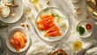 A healthy spread of smoked salmon, fresh herbs, creamy cheese, olive oil, and crusty bread