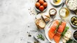 A healthy spread of smoked salmon, fresh herbs, creamy cheese, olive oil, and crusty bread