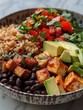 A high-angle view of a simple grain bowl with brown rice, black beans, and avocado.