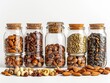 A creative composition of various nuts and seeds in small glass jars, arranged against a white background.
