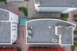 industrial commerce office building with ventilation system and air conditioner fans on roof. aerial overhead view.