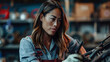 © JuanM - Young mechanic female at work. Empowered woman in the automotive repair business portrait.