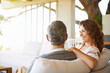© peopleimages.com - Relax, happy or mature couple in home living room for conversation or communication in marriage. Smile, bonding or woman on sofa speaking to man in retirement, house or discussion on couch together