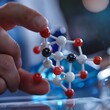 © Samaphon - Close-up of a scientist's hand pointing at a 3D model of a chemical compound, emphasizing the structure and bonds, ideal for educational content
