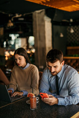 Wall Mural - Businessman and businesswoman are having a coffee break together in a cafe