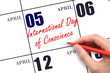 April 5. Hand writing text International Day of Conscience on calendar date. Save the date.