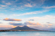 Naples city and Gulf of Naples, Italy. Vesuvius volcano with pink clouds at sunset.
