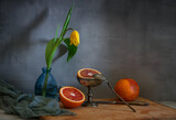 Fototapeta Natura - Still life with cut red orange and yellow tulip.