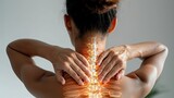 Fototapeta Dinusie - Woman experiencing neck pain with highlighted spine