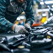 © Narongsak - Car mechanic in uniform and gloves repairs the engine of a modern car at a service station. Car maintenance and diagnostics concept.