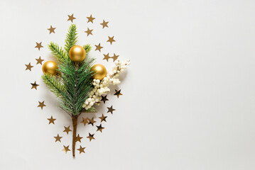 Wall Mural - new year background with christmas tree, golden toys and star confetti on a light white background. 