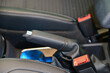 Manual brake in interior of modern car close up