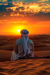 An Arab man looks at the desert. Selective focus.