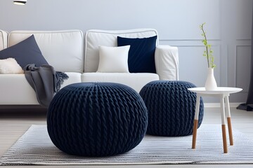 Two knitted poufs near dark blue corner sofa Scandin