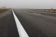 Foggy autumn deserted asphalt road. minimalism