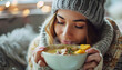 © Oleksiy - Ill young woman eating chicken soup at home