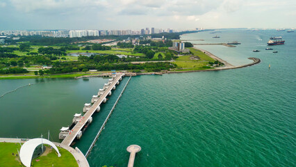 Wall Mural - Marina Barrage, Singapore: Aerial view of cityscape and coastline on a overcast afternoon